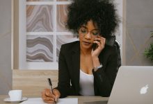 woman-in-black-blazer-holding-smartphone